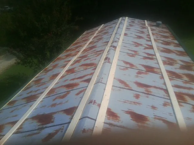 Rusted metal roof panels with new wood purlins before replacement — Storm Damage Roof Repair in Blairs Mills by Roofing Brothers