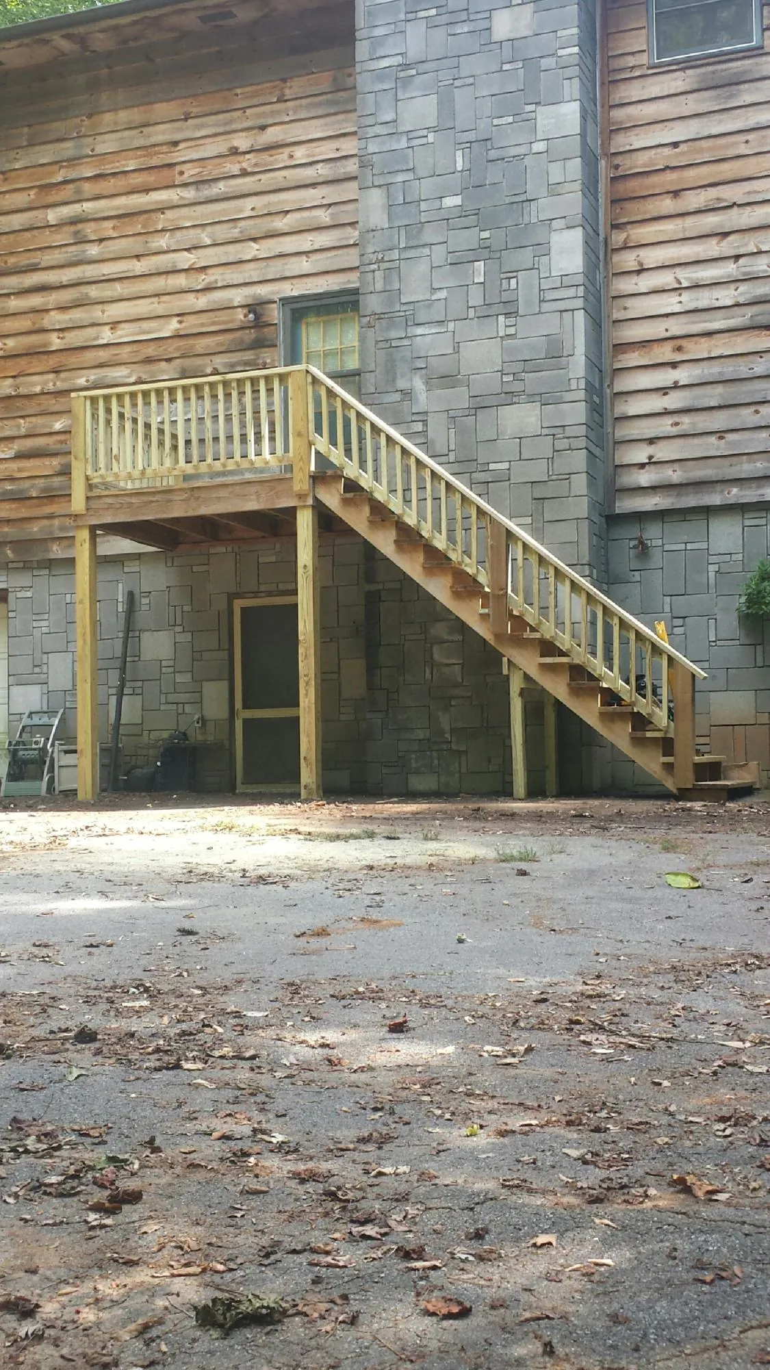 New pressure treated deck and stair landing on a log home in Blairs Mills