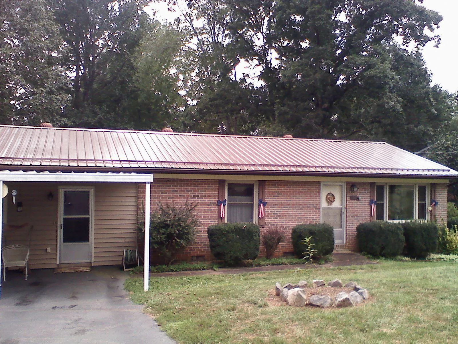 Bronze metal roof and carport on a brick ranch home — Roof Repair work by our crew in Blairs Mills
