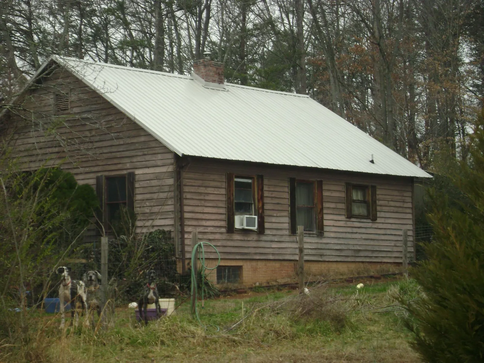 White metal roof on an old wood sided farmhouse, from a Metal Roof Installation job in Blairs Mills